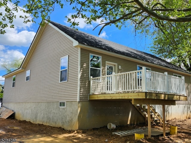 view of home's exterior featuring a wooden deck