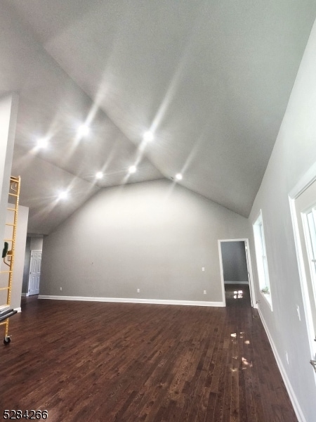 bonus room featuring lofted ceiling and dark hardwood / wood-style flooring