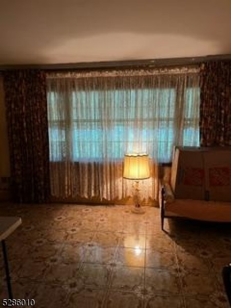 unfurnished room featuring tile floors and a wealth of natural light