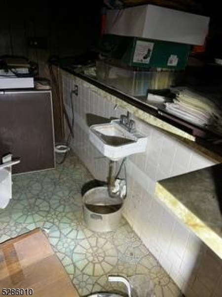 bathroom with tile floors and sink