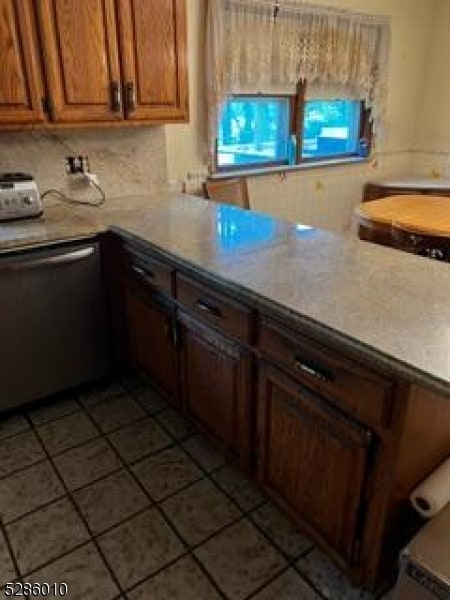 kitchen with dishwasher, tile flooring, and backsplash