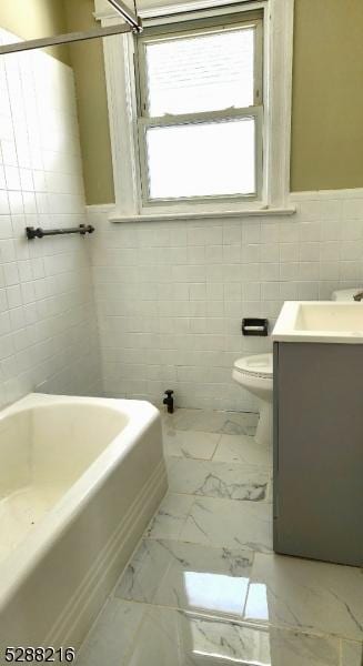 full bathroom featuring shower / bathing tub combination, vanity, tile walls, and toilet