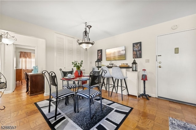 dining space with light parquet flooring