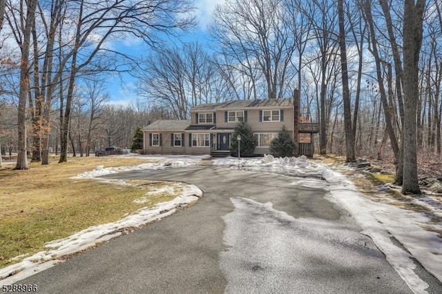 view of front of property with driveway and a chimney