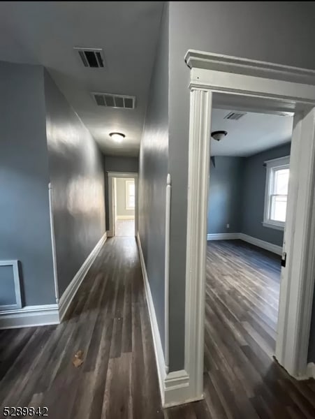 corridor featuring dark hardwood / wood-style flooring