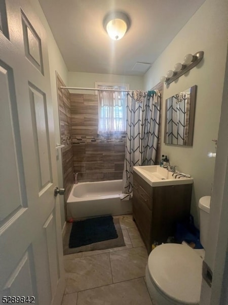 full bathroom with shower / bathtub combination with curtain, vanity with extensive cabinet space, tile flooring, and toilet