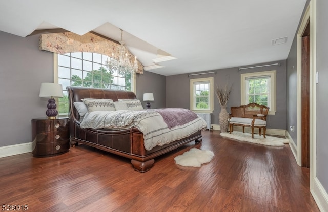 bedroom featuring radiator and hardwood / wood-style flooring