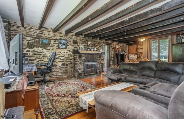 living room featuring beamed ceiling, hardwood / wood-style flooring, and a fireplace