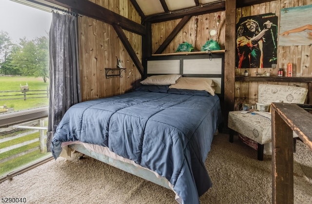 carpeted bedroom with wooden walls and vaulted ceiling