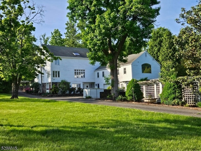 back of property featuring a lawn