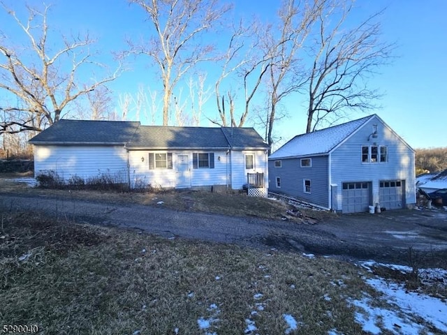 snow covered property featuring a garage