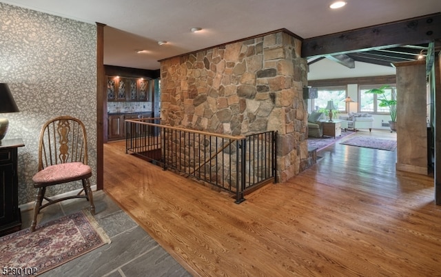 hall featuring beam ceiling and hardwood / wood-style floors