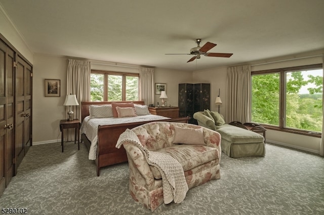 bedroom with a closet, dark colored carpet, and ceiling fan