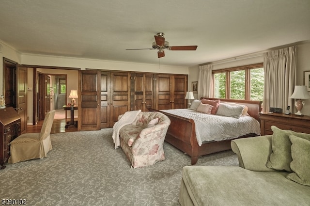 bedroom featuring carpet, ceiling fan, and crown molding