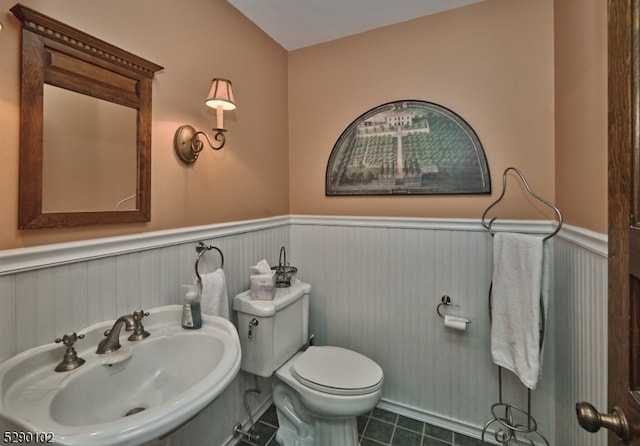 bathroom with tile floors, sink, and toilet