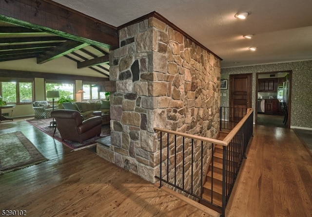 hallway with lofted ceiling with beams and wood-type flooring