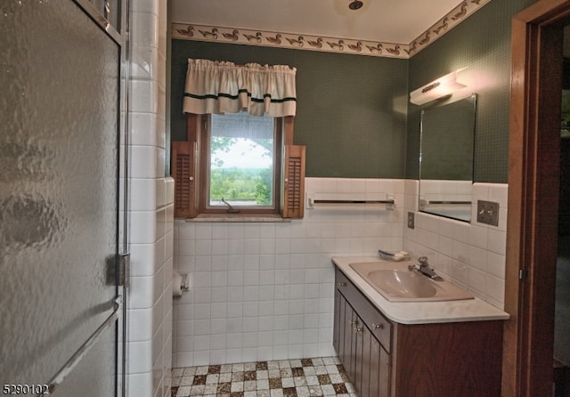 bathroom featuring walk in shower, tile floors, tile walls, tasteful backsplash, and vanity