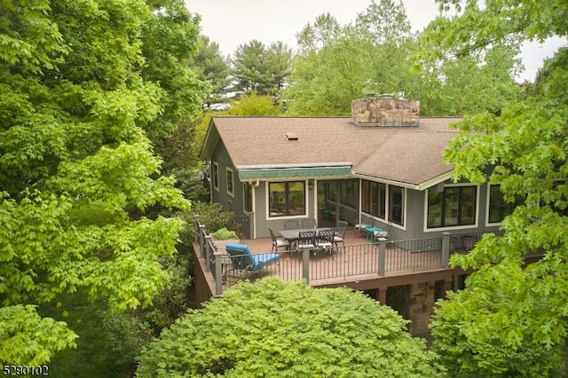 back of house featuring a wooden deck