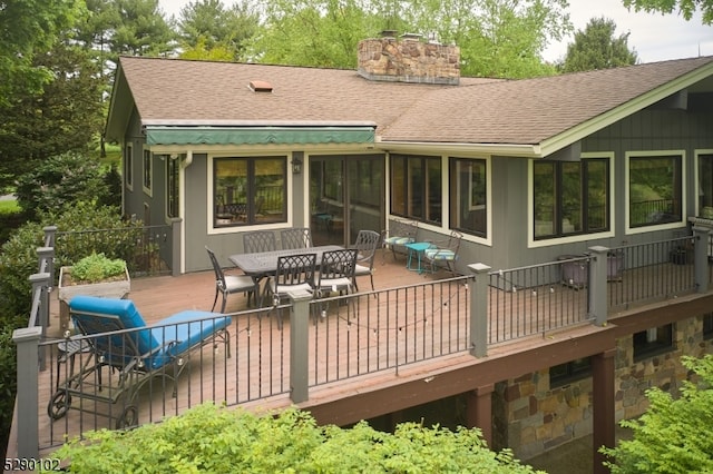 back of house featuring a wooden deck