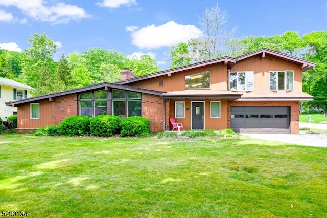 view of front of house featuring a garage and a front lawn