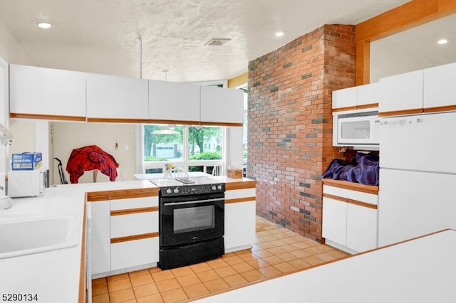 kitchen with tile countertops, white appliances, white cabinetry, and light tile floors