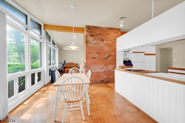 dining room with lofted ceiling with beams