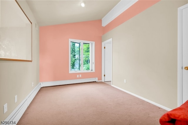 spare room featuring carpet flooring, vaulted ceiling, and a baseboard heating unit