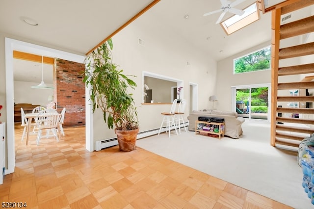 living room with a baseboard radiator, a skylight, ceiling fan, high vaulted ceiling, and light colored carpet