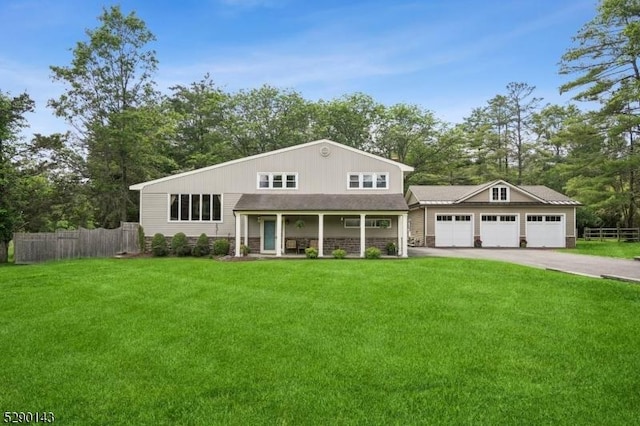 268 Stonehouse Rd, Bernards Twp, NJ 07920 - view of front facade with a porch, driveway, an attached garage, and view of scattered trees