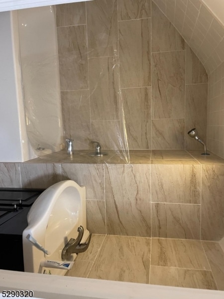 bathroom with tile walls