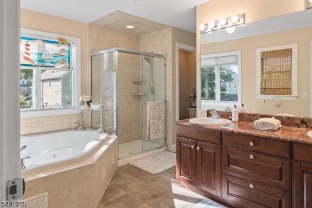 bathroom featuring tile flooring, independent shower and bath, and oversized vanity