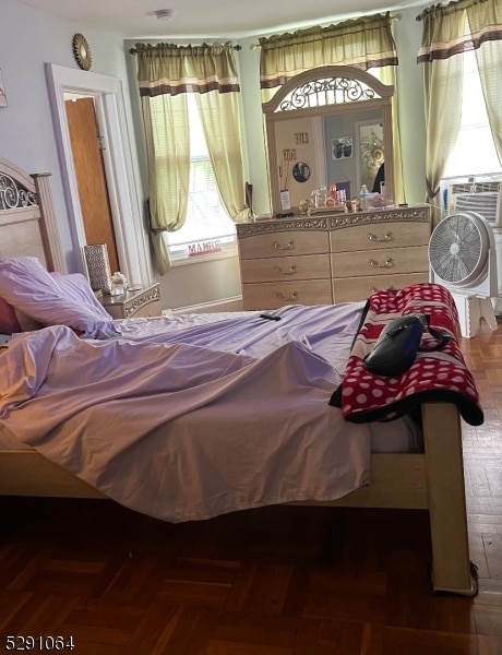 bedroom with dark parquet flooring