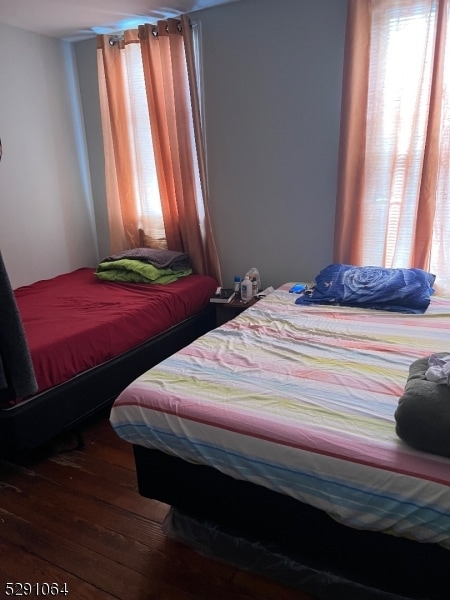 bedroom featuring hardwood / wood-style flooring and multiple windows