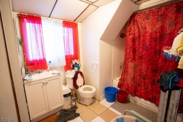 full bathroom featuring tile patterned floors, vanity, shower / bathtub combination with curtain, and toilet