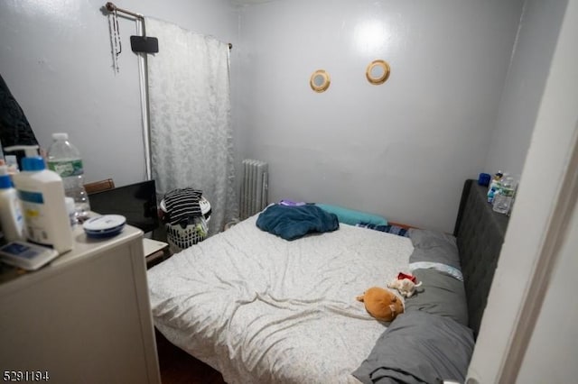 bedroom featuring radiator