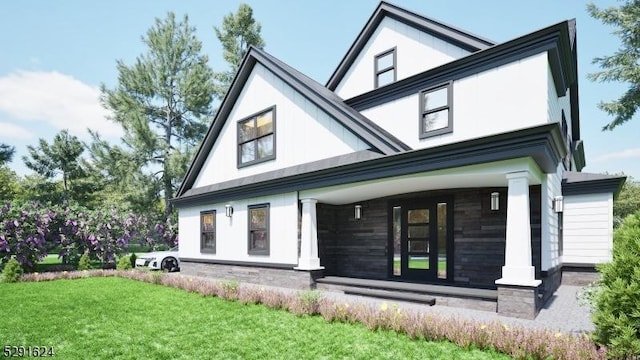 back of house featuring a yard and covered porch