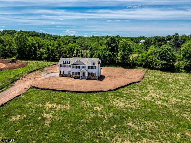 bird's eye view with a wooded view