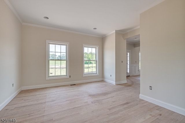 unfurnished room featuring light hardwood / wood-style floors and ornamental molding