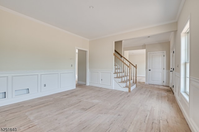 unfurnished room with light hardwood / wood-style floors and ornamental molding