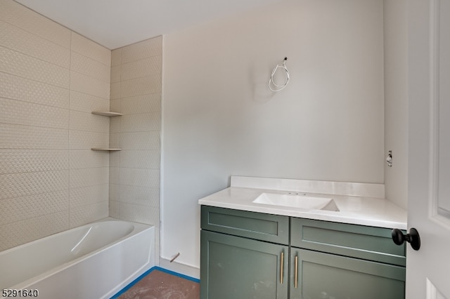 bathroom featuring vanity and tiled shower / bath