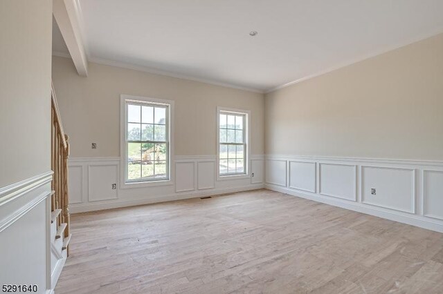 stairway with wood-type flooring and ornamental molding