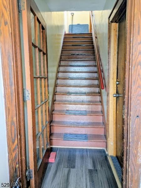 stairs featuring hardwood / wood-style flooring