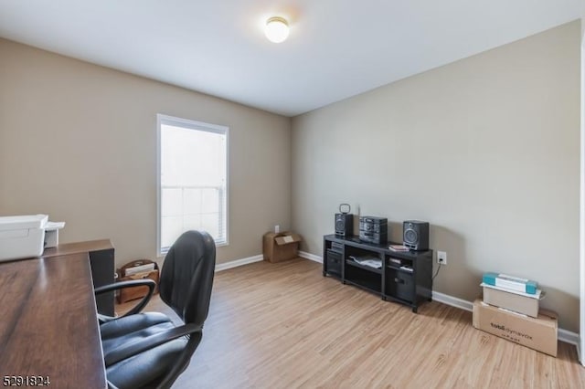 home office with light hardwood / wood-style floors