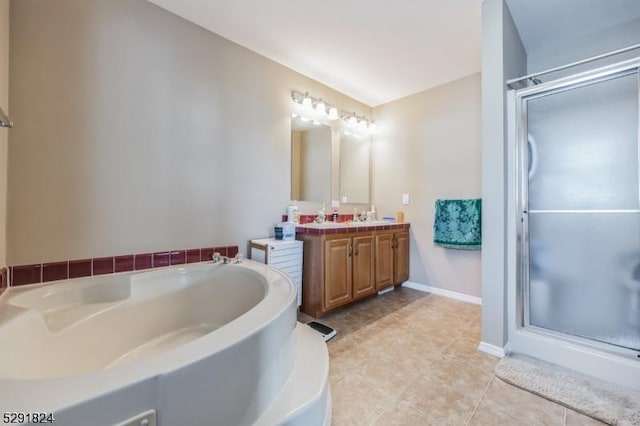 bathroom featuring independent shower and bath, vanity, and tile patterned flooring