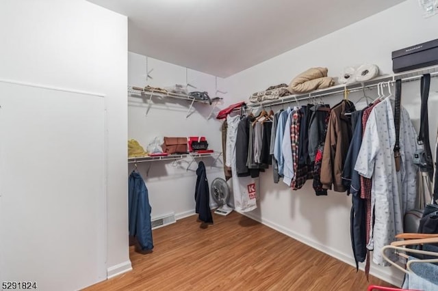 spacious closet with light hardwood / wood-style floors