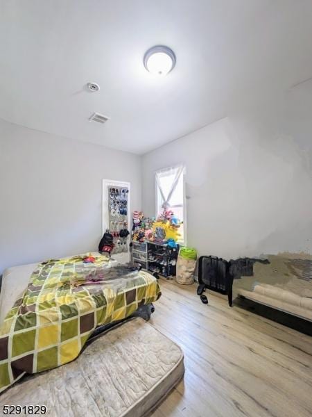 bedroom featuring wood-type flooring