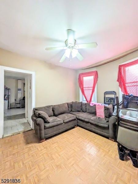 living room featuring light parquet flooring and ceiling fan