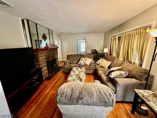 living room featuring a fireplace and hardwood / wood-style flooring