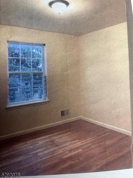 empty room featuring dark hardwood / wood-style floors