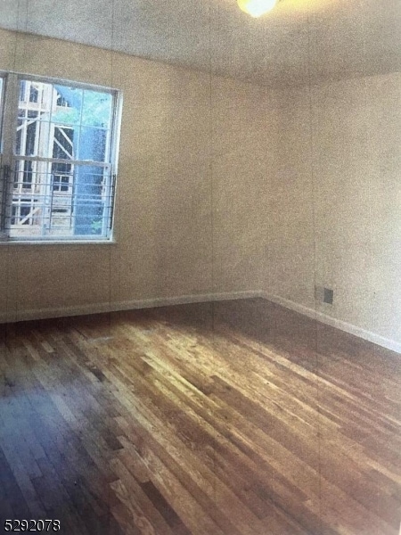 empty room with dark hardwood / wood-style floors